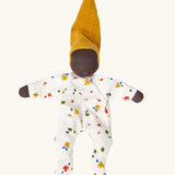 Käthe Kruse Waldorf Doll Nini Sunshine. Washable cotton toy with white floral print outfit and ocre yellow hat with dark skin.