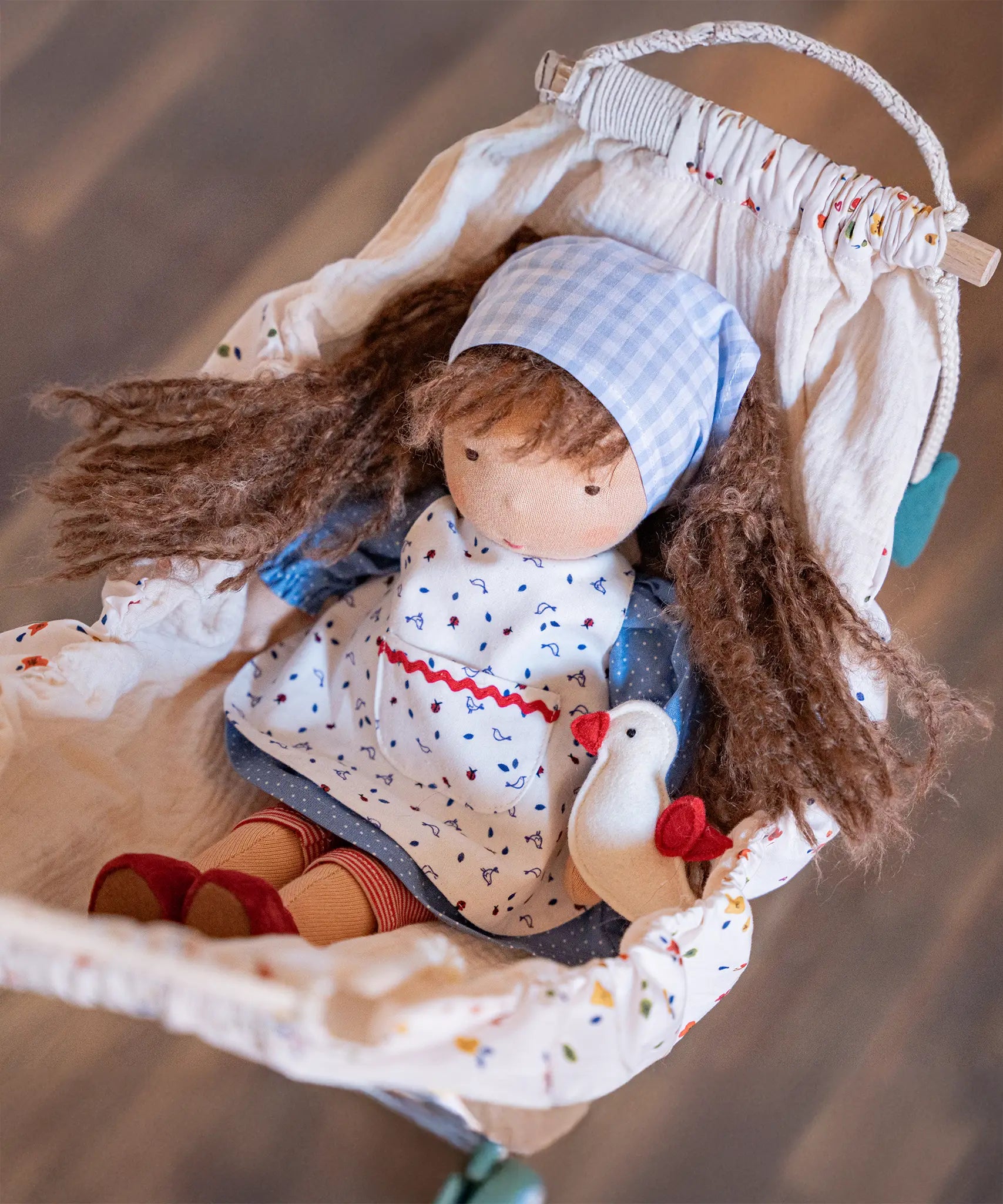 Käthe Kruse Waldorf doll Tilda placed in a dolls pram. 
