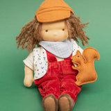 Käthe Kruse Waldorf doll Toni in a sitting position with a small felt squirrel on it's lap. 