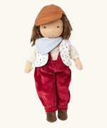 Käthe Kruse Waldorf doll Toni. Handmade cotton doll with white skin and brown hair with red dungaree, white t-shirt, printed waistcoat, light blue bandanna style bib and brown hat. 