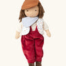Käthe Kruse Waldorf doll Toni. Handmade cotton doll with white skin and brown hair with red dungaree, white t-shirt, printed waistcoat, light blue bandanna style bib and brown hat. 