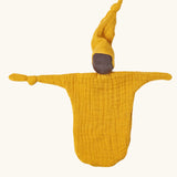 Käthe Kruse small Waldorf Imp comforter doll with ochre yellow outfit and hat and dark skin. 