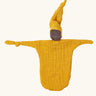 Käthe Kruse small Waldorf Imp comforter doll with ochre yellow outfit and hat and dark skin. 
