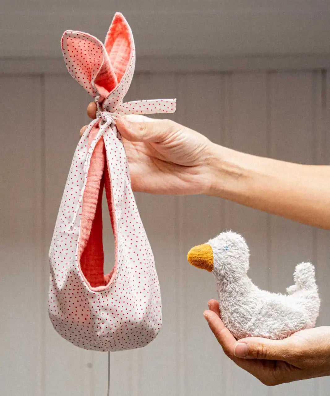 Käthe Kruse white duckling nest Animal music box soft toy. Small duckling soft toy with a white red spotted material nest.