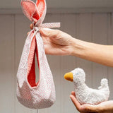 Käthe Kruse white duckling nest Animal music box soft toy. Small duckling soft toy with a white red spotted material nest.