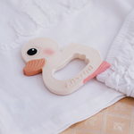 Hevea Natural Rubber Teether - Kawan the Duck on white baby clothes layed out