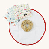 An open Keep Leaf food wrap with a bagel inside for size reference with a bloom, geo and robot food wrap on top 