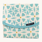 Keep Leaf food wrap in geo design. A cream colour organic cotton wrap for food with blue geo shapes printed all over and light pink trim. Features a velcro lid for easy fastening