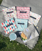 A group of Keep Leaf large baggies outside on a grey blanket showing the mesh, geo, robot, stars, new fruit and bloom designs