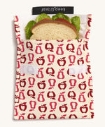 Keep Leaf large baggie in new fruit design. A cream colour organic cotton pouch for food with red apples and pears outline printed all over. Features a velcro lid for easy fastening and a sandwich inside for size reference