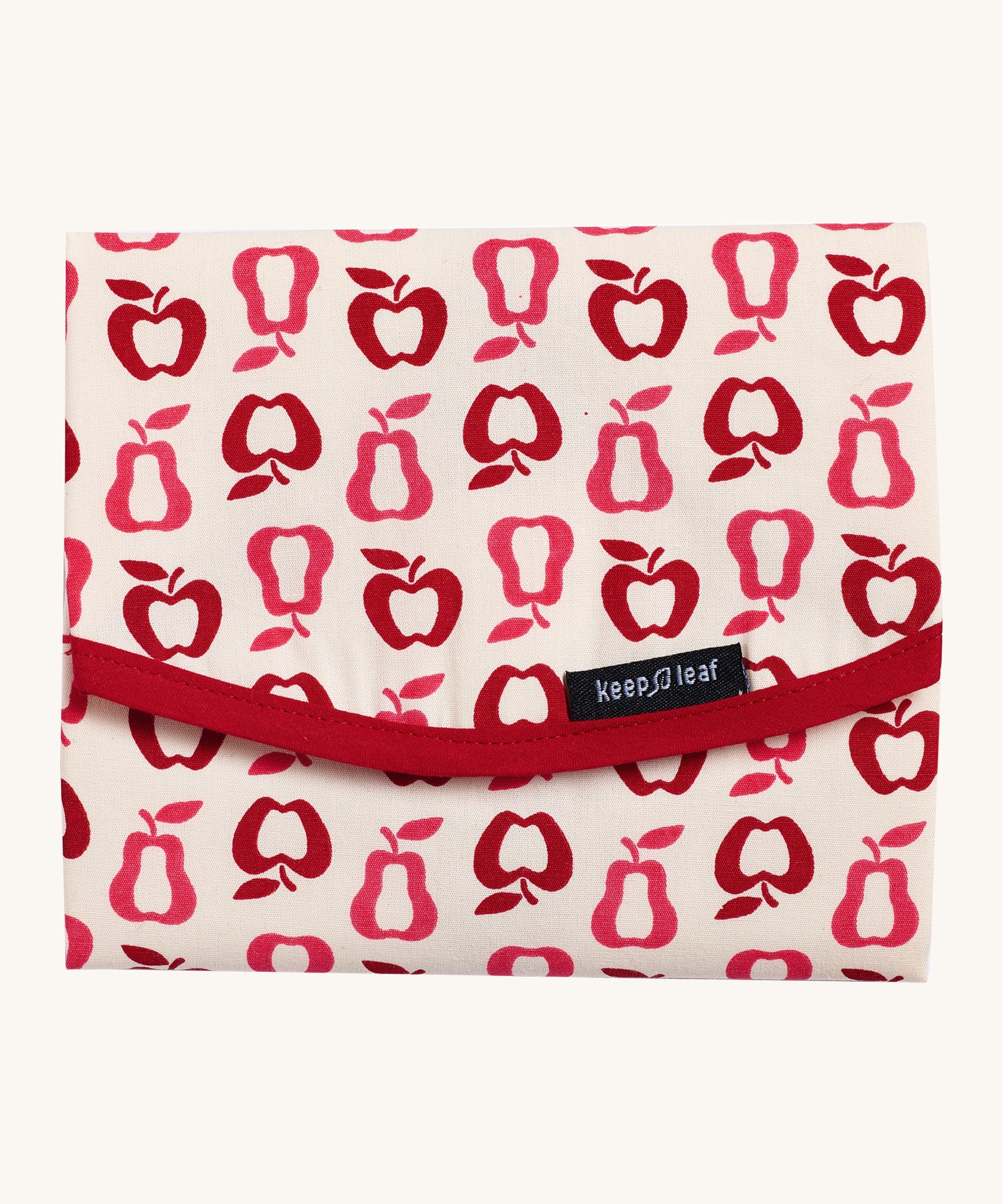 Keep Leaf food wrap in new fruit design. A cream colour organic cotton wrap for food with red apple and pear outlines printed all over and light pink trim. Features a velcro lid for easy fastening