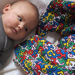 A closer look at the colours and shapes on the Etta Loves X Keith Haring Extra Large Organic Cotton Baby Muslin Square - Brazil