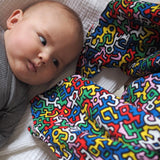 A closer look at the colours and shapes on the Etta Loves X Keith Haring Extra Large Organic Cotton Baby Muslin Square - Brazil