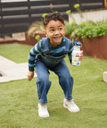 A child holding a car print Kid Kanteen 12oz Narrow Sippy Bottle. 