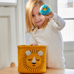 A child putting their hand into the The Roommate Mini Quilted Basket - Lion