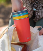 Klean Kanteen stainless steel 16oz pint cups in a 4 Pack in evening sky colours stacked together in a person's hands.