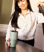 Adult grabbing a 16oz Klean Kanteen in iceberg green