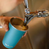 Pint being poured into a blue Klean Kanteen stainless steel 16oz pint cup.