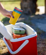 Klean Kanteen stainless steel 16oz pint cups in a 4 Pack in evening sky colours stacked together in a person's hands being placed into a cool box.