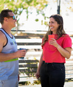 Two people drinking from Klean Kanteen stainless steel 16oz pint cups in evening sky colours .
