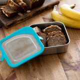 Klean Kanteen 20oz food box filled with baked goods on a wooden worktop next to some bananas