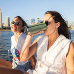 A person drinking from a sea spray green coloured Klean Kanteen 20oz TKWide .