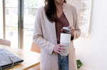 Close up of woman holding the removable flip lid above her Klean Kanteen 26oz insulated drinks tumbler