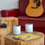 2 Klean Kanteen stainless 8oz tumblers in barely blue with their lids on top standing on a wooden table 