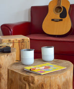 2 Klean Kanteen stainless 8oz tumblers in barely blue with their lids on top standing on a wooden table 