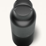 A close up of the Klean Kanteen 20oz Classic rise black insulated classic reusable steel water bottle showing the handle detail on the loop cap