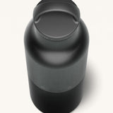 A close up of the Klean Kanteen 20oz Classic rise black insulated classic reusable steel water bottle showing the handle detail on the loop cap