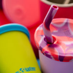 Close up of the Klean Kanteen removable kid cup straw lids in the pink tie dye colour