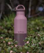 Klean Kanteen 20oz dusty orchid stainless steel  insulated classic bottle on a bed of flowers