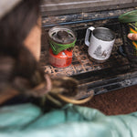 Close up of woman pouring some water into the Klean Kanteen 12oz eco-friendly metal camping mug