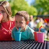 Child drinking from a blue Klean Kanteen 10oz/296ml Steel Kid Cups with Straw Lid.