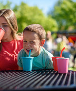Child drinking from a blue Klean Kanteen 10oz/296ml Steel Kid Cups with Straw Lid.