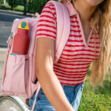 Klean Kanteen Rise Insulated Classic Bottle with Flip Seal Cap in limited edition Cayenne colourway in a woman's backpack bottle pocket. 