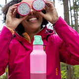Woman on a picnic with Klean Kanteen Rise Insulated Classic Bottle with Flip Seal Cap in limited edition Cashmere Rose colourway.