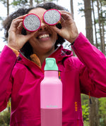 Woman on a picnic with Klean Kanteen Rise Insulated Classic Bottle with Flip Seal Cap in limited edition Cashmere Rose colourway.