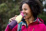 Hiker drinking from Klean Kanteen Rise Insulated Classic Bottle with Flip Seal Cap in limited edition Wax Yellow colourway.