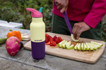 Klean Kanteen Rise Insulated Classic Bottle with Flip Seal Cap in limited edition Wax Yellow on an outdoor picnic table. 