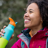 Hiker holding Klean Kanteen Rise Insulated Classic Bottle with Flip Seal Cap in limited edition Baltic colourway.