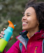 Hiker holding Klean Kanteen Rise Insulated Classic Bottle with Flip Seal Cap in limited edition Baltic colourway.