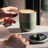A klean Kanteen sea spray lowball tumbler next to the rise slide lid showing the silicone ring around the cap