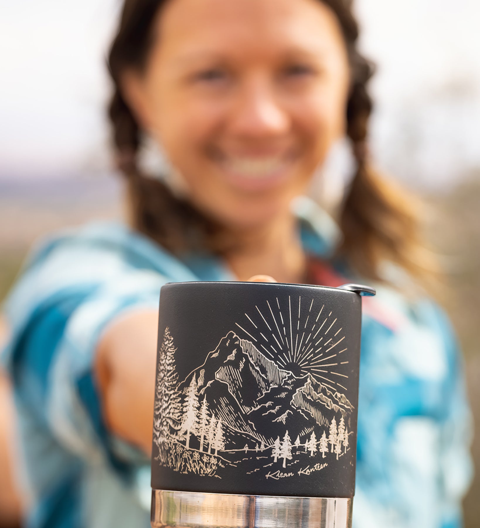 An adult holding the Klean Kanteen 12oz Insulated Mug in Black Mountain