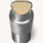 A close up of the Klean Kanteen 16oz reusable stainless steel reflect water bottle available at Babipur showing the bamboo detail on top of the loop cap. 