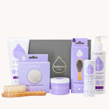 Kokoso Fragrance Free Collection Gift Set. Includes Baby Lotion, Baby-Soft Balm Stick, Natural Brush, Natural Sponge, Coconut Oil, Gentle Hair & Body Wash, on a cream background