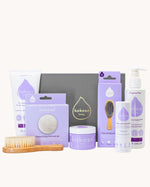 Kokoso Fragrance Free Collection Gift Set. Includes Baby Lotion, Baby-Soft Balm Stick, Natural Brush, Natural Sponge, Coconut Oil, Gentle Hair & Body Wash, on a cream background