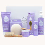Kokoso Scented Baby Collection - Coconut & Lavender, showing the contents of the Collection. Cocont Oil, Baby Soft Balm Stick, Gentle Hair & Body Wash, Coconut Oil Baby Lotion, Natural Brush, and a Sponge. The items are displayed on a cream background