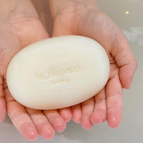 A close up of a child holding the Kokoso Organic Baby Soap available at Babipur. 